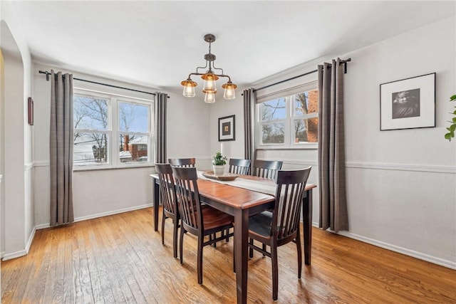 dining space featuring a notable chandelier and light hardwood / wood-style flooring