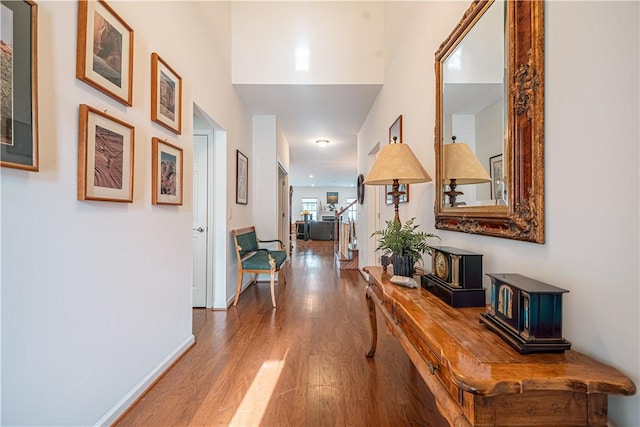 hallway with hardwood / wood-style flooring