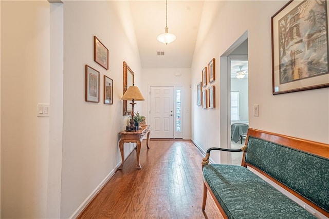 interior space featuring hardwood / wood-style flooring and vaulted ceiling