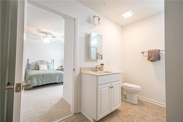 bathroom featuring ceiling fan, vanity, and toilet