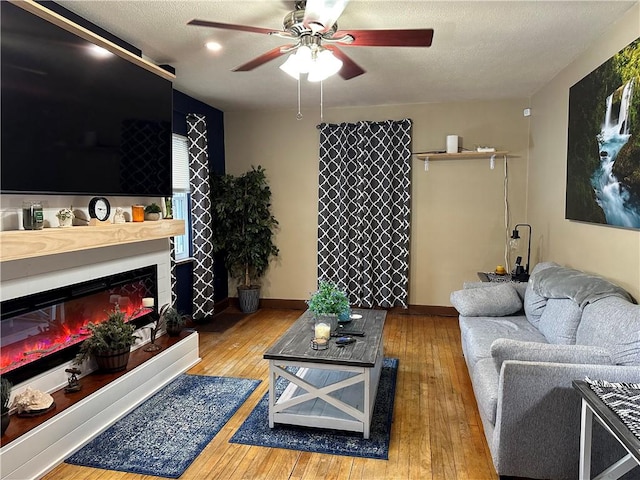 living room with wood-type flooring and ceiling fan