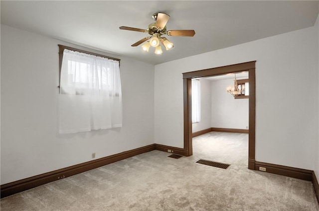 carpeted spare room featuring ceiling fan