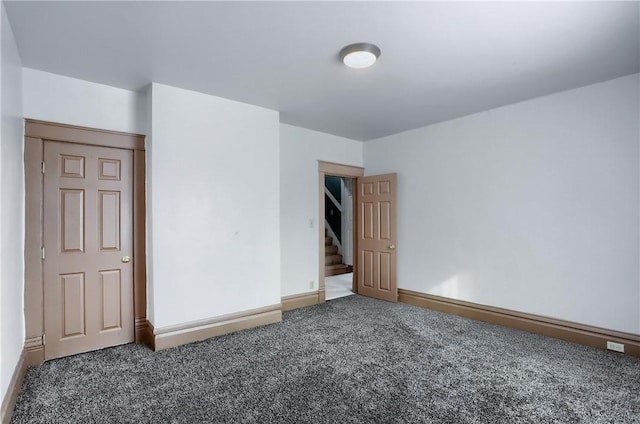 empty room featuring dark colored carpet