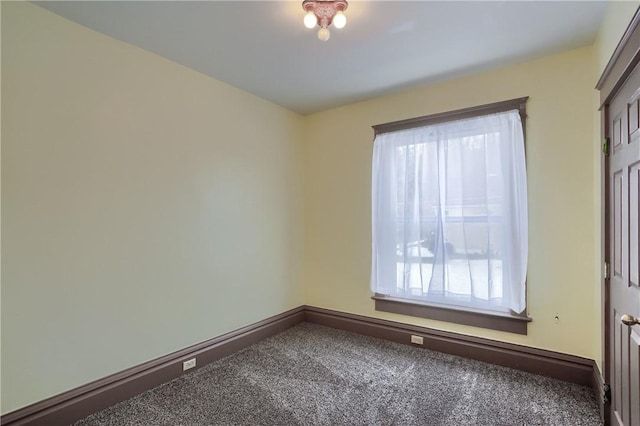 carpeted spare room featuring a healthy amount of sunlight