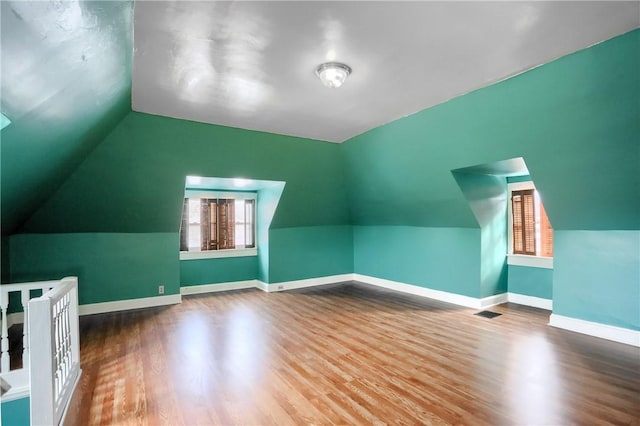 bonus room featuring lofted ceiling and hardwood / wood-style floors