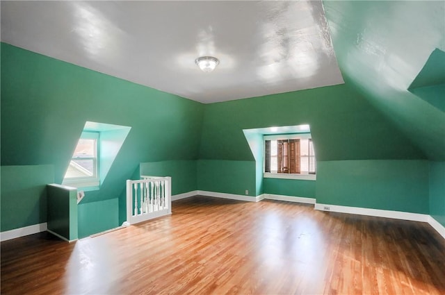 bonus room featuring vaulted ceiling and hardwood / wood-style floors