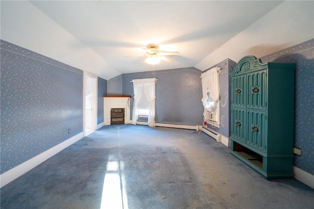 unfurnished living room featuring vaulted ceiling, ceiling fan, and a baseboard radiator