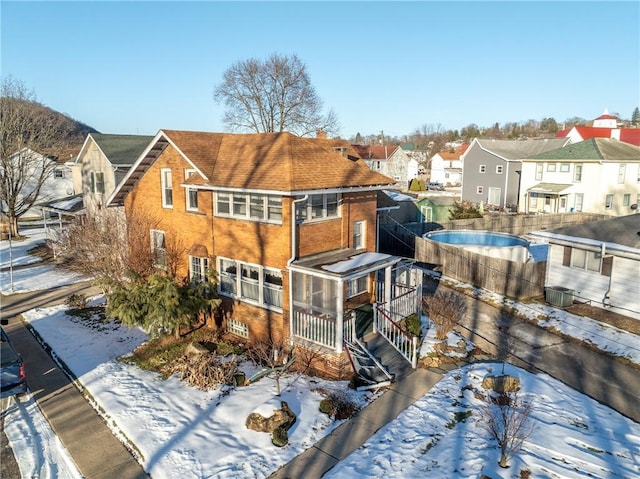 view of snow covered rear of property