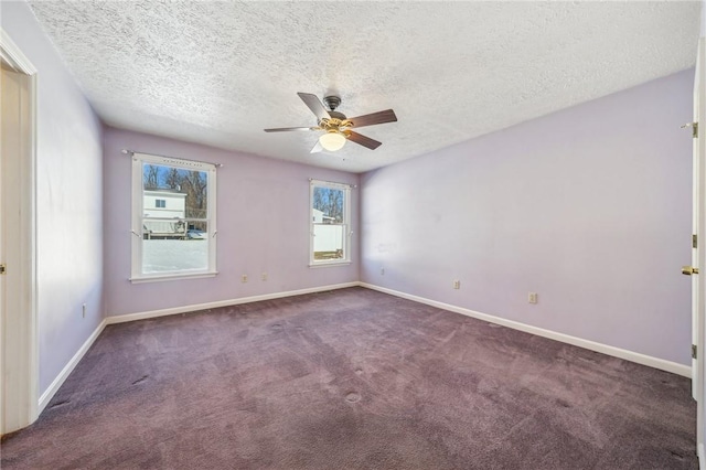 unfurnished room with ceiling fan, a textured ceiling, and dark carpet