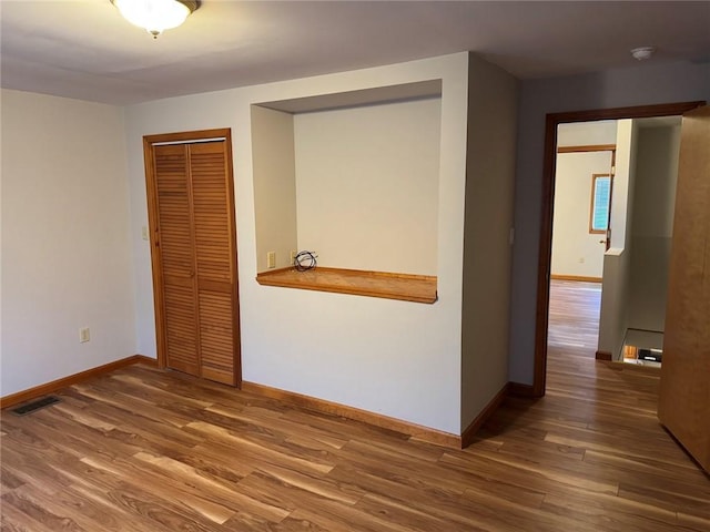 interior space featuring dark wood-type flooring and a closet