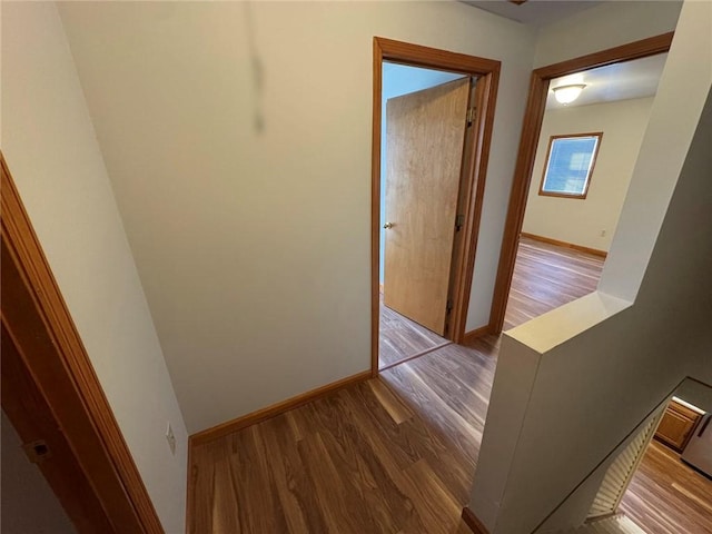 hallway with hardwood / wood-style flooring