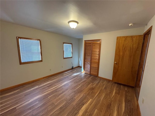 unfurnished bedroom featuring dark hardwood / wood-style flooring