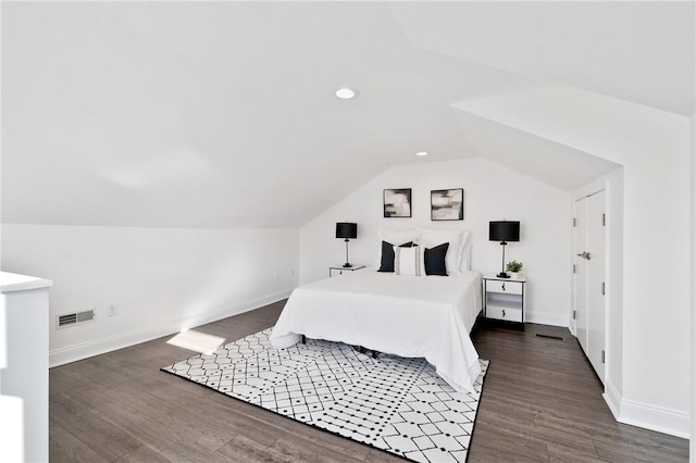 bedroom featuring dark wood-type flooring and vaulted ceiling