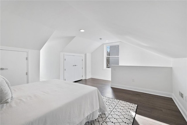 bedroom featuring lofted ceiling and dark wood-type flooring