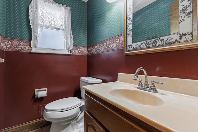 bathroom featuring vanity, tile patterned floors, and toilet