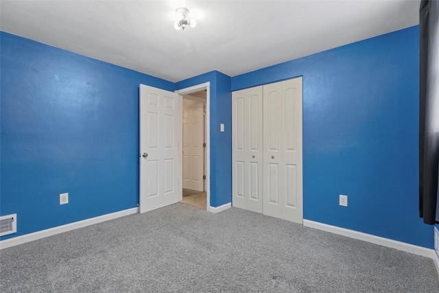 unfurnished bedroom featuring carpet and a closet