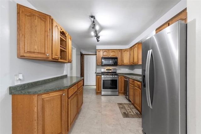 kitchen with light tile patterned flooring and appliances with stainless steel finishes