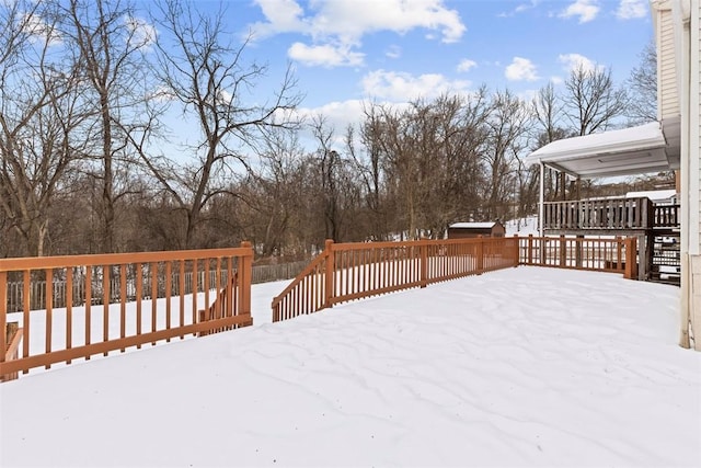 yard layered in snow featuring a wooden deck