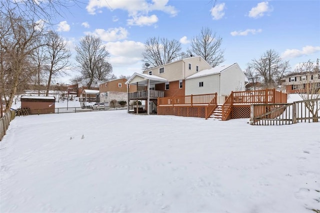 yard covered in snow with a deck