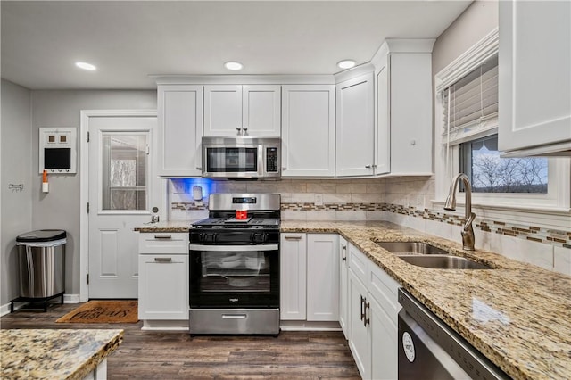 kitchen featuring sink, dark wood-type flooring, stainless steel appliances, and white cabinets