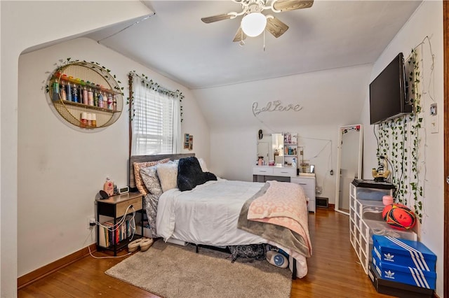 bedroom with lofted ceiling, hardwood / wood-style floors, and ceiling fan