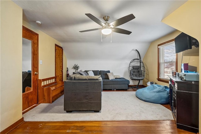 living room with vaulted ceiling, dark wood-type flooring, and ceiling fan