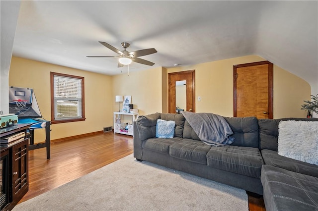 living room with wood-type flooring, ceiling fan, and vaulted ceiling