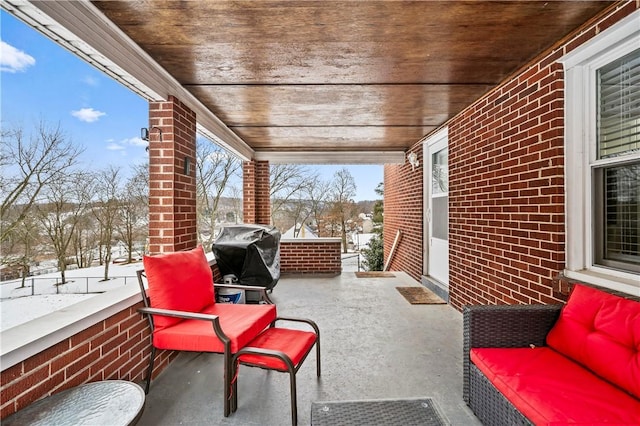 snow covered patio featuring grilling area