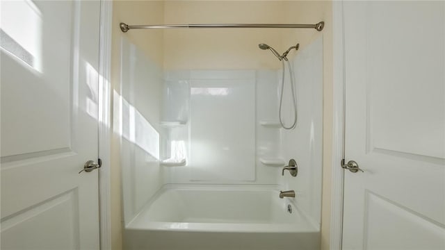 bathroom with bathing tub / shower combination