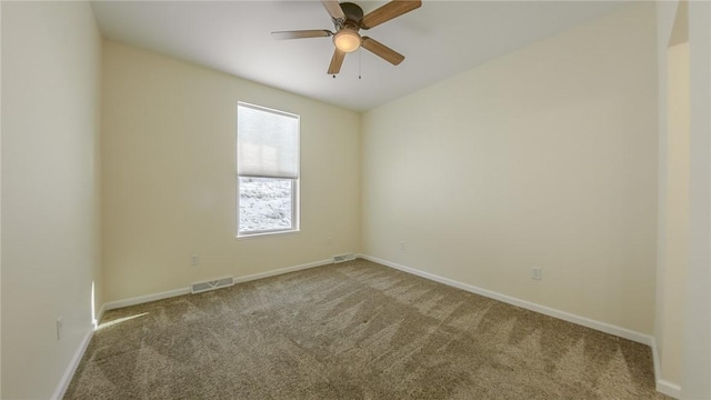 carpeted spare room with ceiling fan