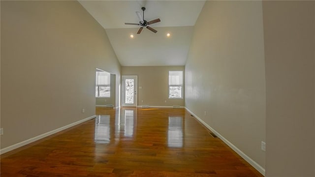 unfurnished living room featuring wood-type flooring, high vaulted ceiling, and ceiling fan