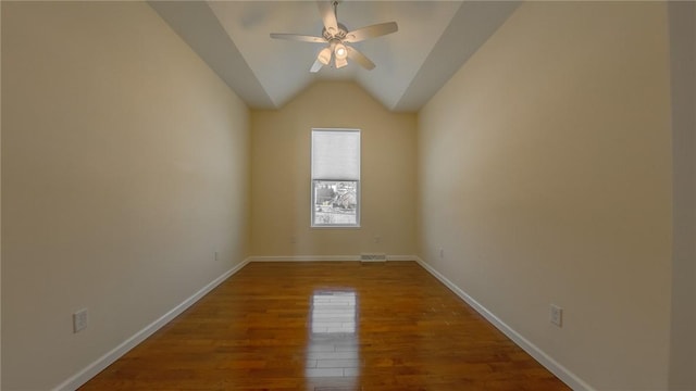 empty room featuring hardwood / wood-style flooring, vaulted ceiling, and ceiling fan