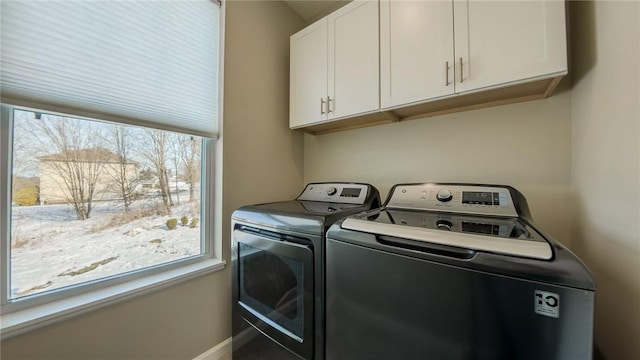 laundry area featuring cabinets and washing machine and clothes dryer