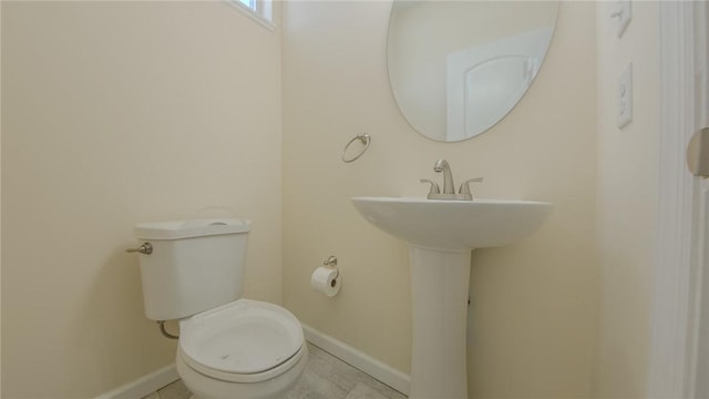 bathroom featuring tile patterned flooring and toilet