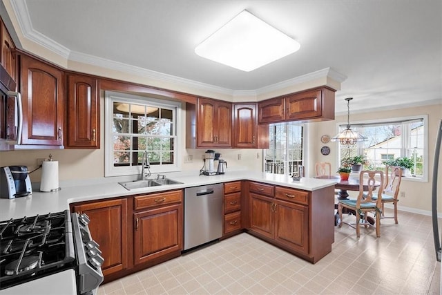 kitchen with sink, stainless steel appliances, ornamental molding, decorative light fixtures, and kitchen peninsula