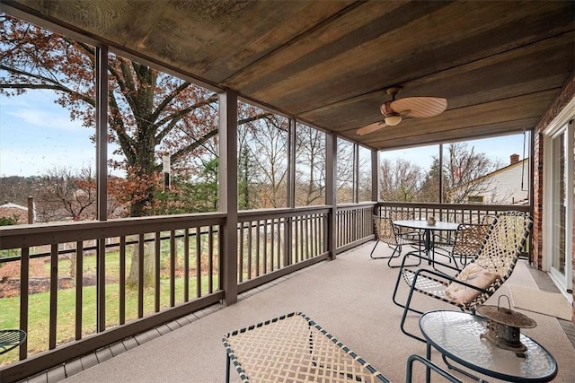 sunroom / solarium with wood ceiling and ceiling fan