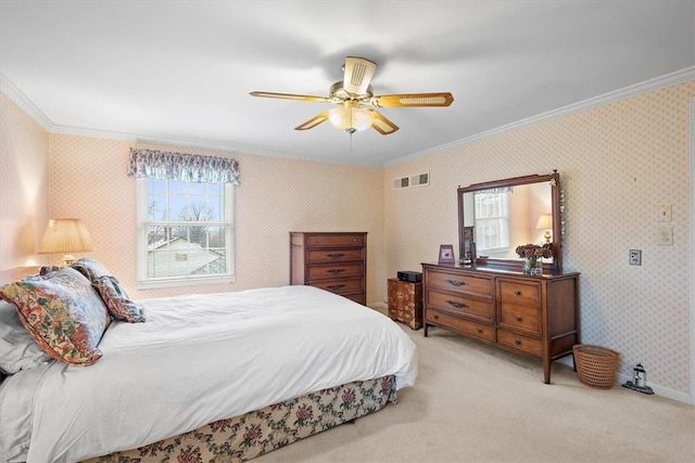 carpeted bedroom featuring crown molding and ceiling fan