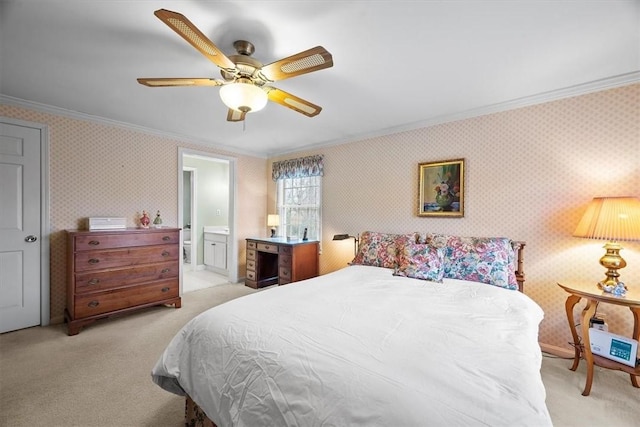 carpeted bedroom with ornamental molding, ensuite bathroom, and ceiling fan