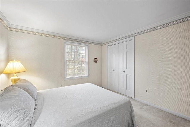 carpeted bedroom with crown molding and a closet