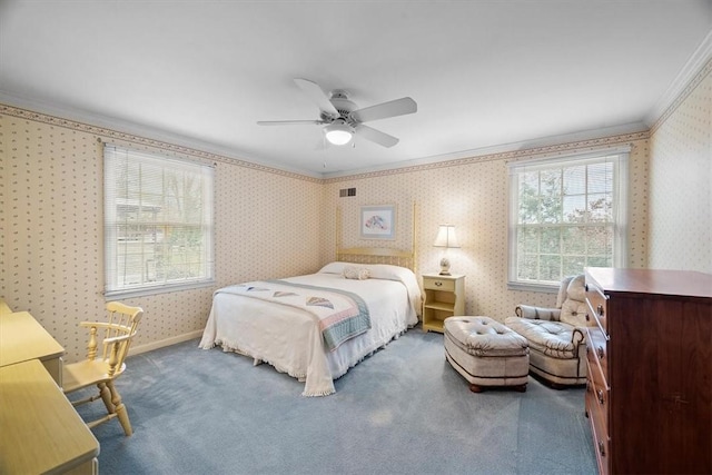 carpeted bedroom featuring crown molding and ceiling fan