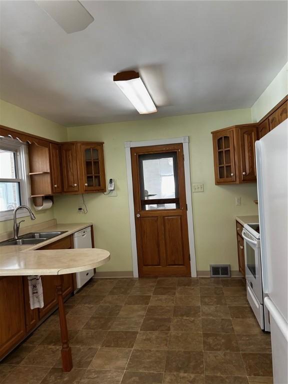 kitchen featuring sink and white appliances