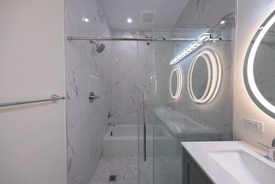 bathroom featuring an enclosed shower and vanity