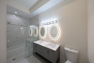 full bathroom with vanity, shower with separate bathtub, and toilet