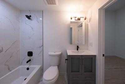 full bathroom with vanity, tiled shower / bath, and toilet