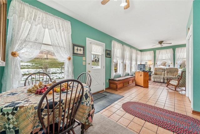 sunroom featuring ceiling fan and plenty of natural light