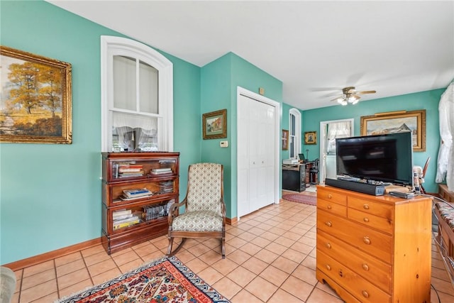 sitting room with ceiling fan and light tile patterned floors