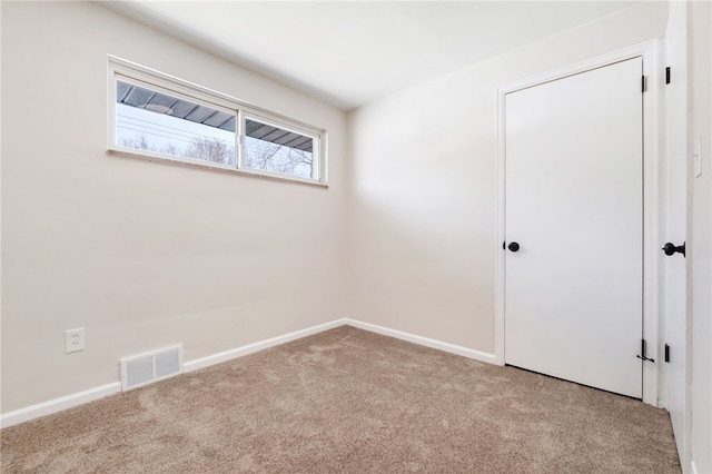 unfurnished room with light carpet