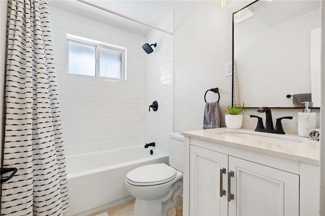 full bathroom with vanity, shower / tub combo, and toilet