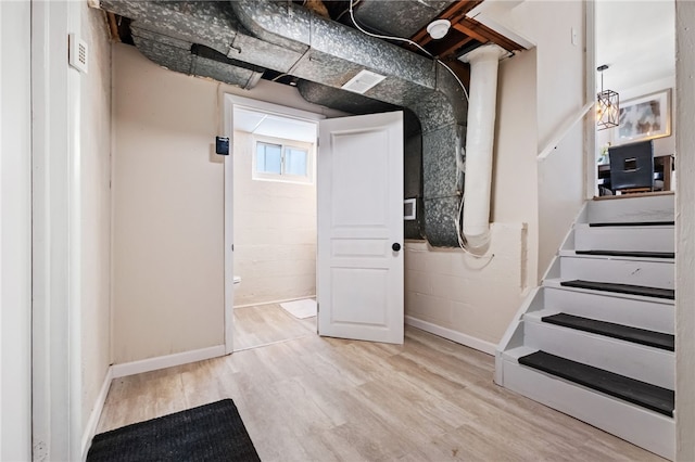 basement with light hardwood / wood-style flooring