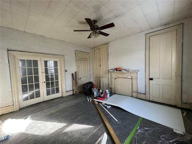 interior space with french doors and ceiling fan